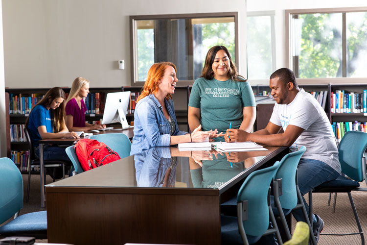 Students studying at a table in the library.