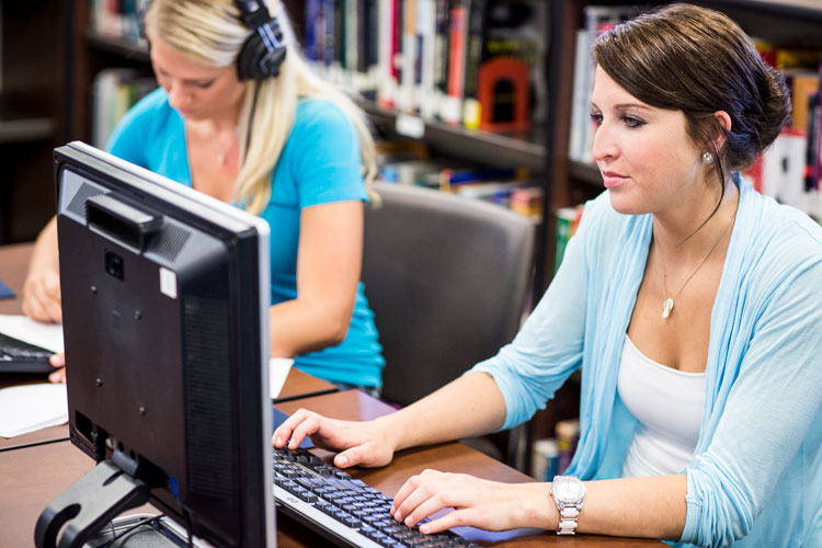 Student working on a computer in the library.