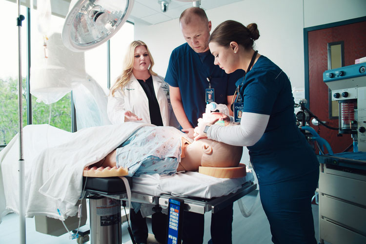 CRNA students practicing in the OR room in the Interprofessional Learning Center