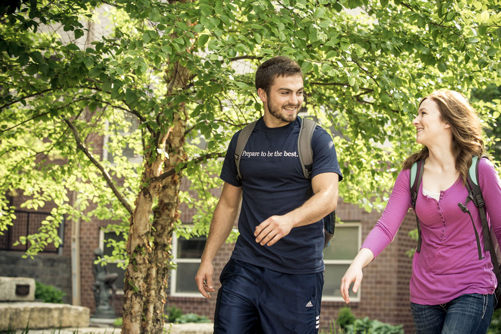 Clarkson College students walking together in the courtyard